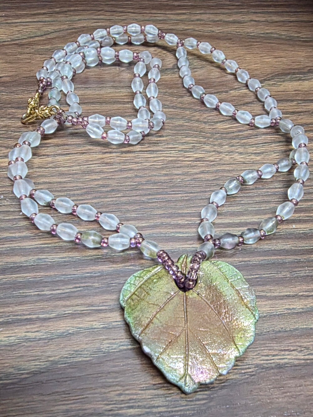 Pink Beaded Necklace with Green Leaf Pendant
